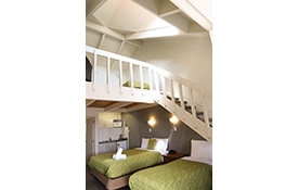 queen-size bed and single bed on ground floor